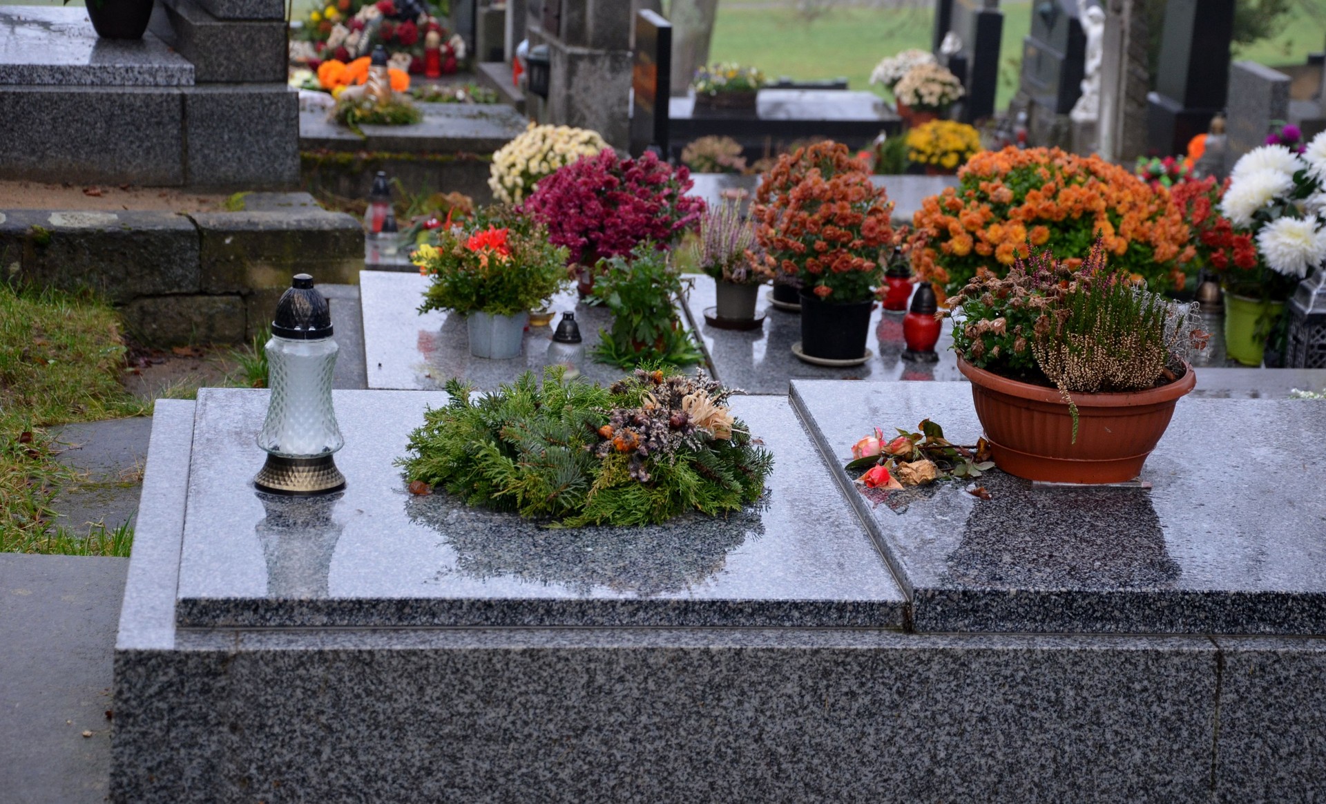 decoration of graves to order. preparation for winter season by placing twigs and wreaths, cleaning granite stone tombstones and lighting candles. tombstone and stonework in your area. cover of needle, graveyard